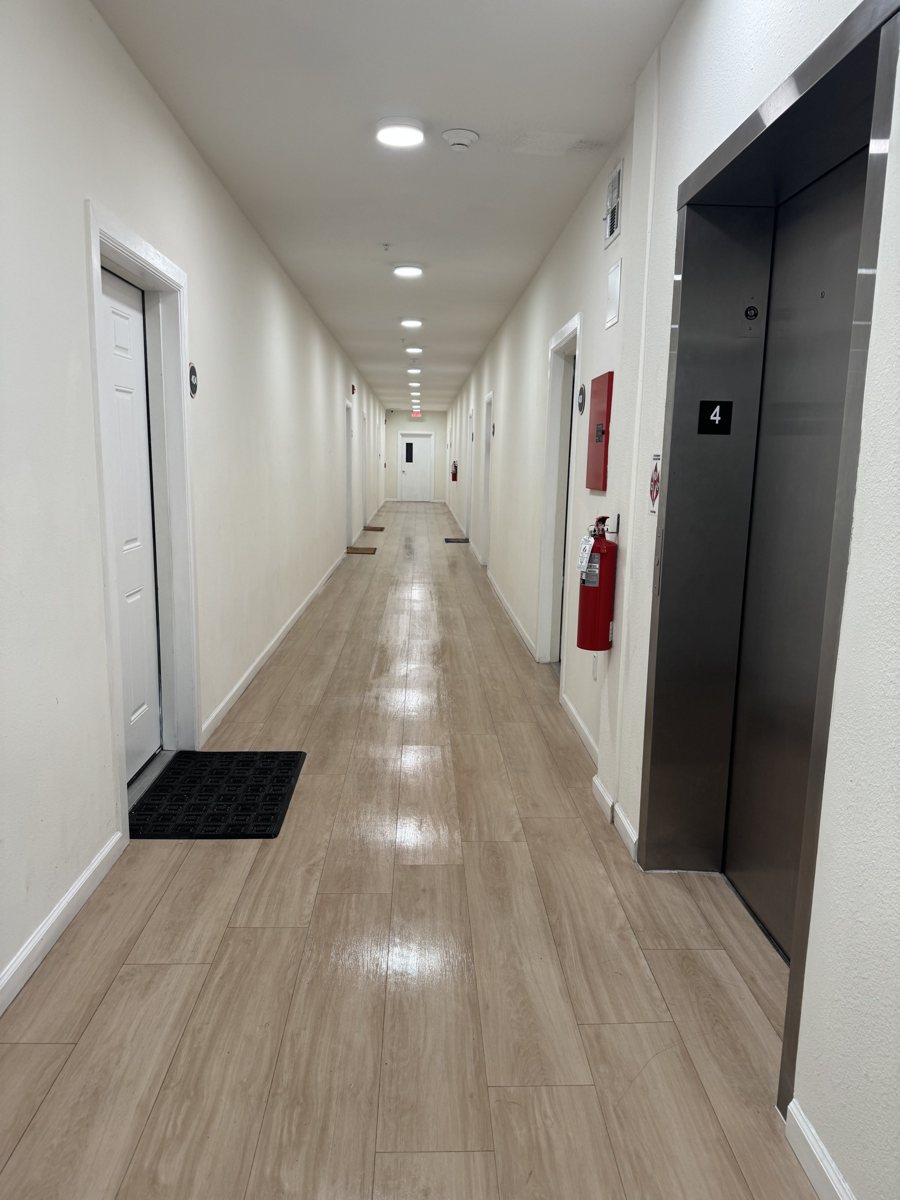 Finished interior corridor at Bradenton Lofts with wood style flooring